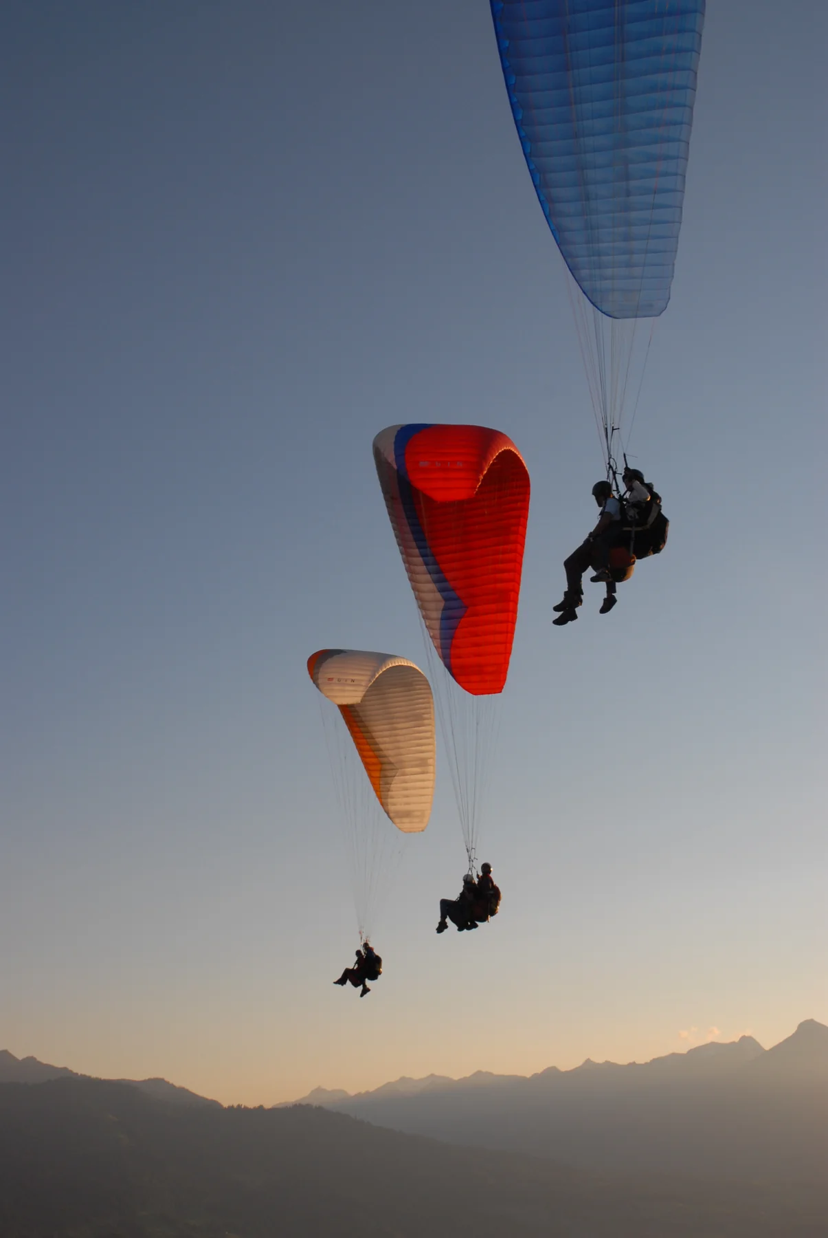 Paragliders flying above the mountains near Interlaken